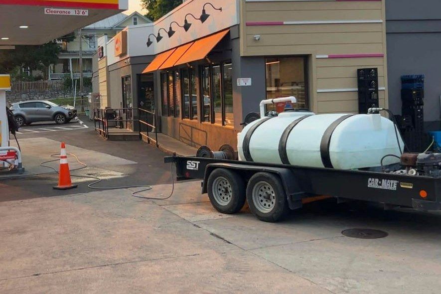 Chem-Clean water tank trailer set up at a gas station storefront at dawn