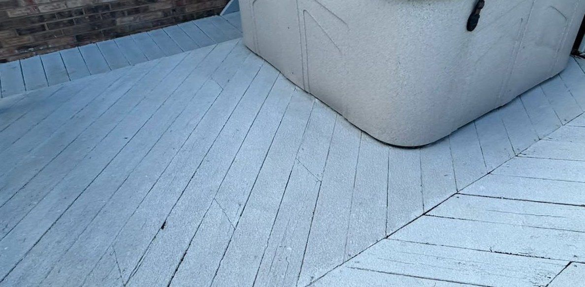 The same deck after washing, clean light gray boards