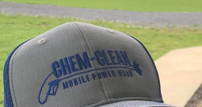 Gray trucker cap embroidered with the Chem-Clean Mobile Power Wash logo