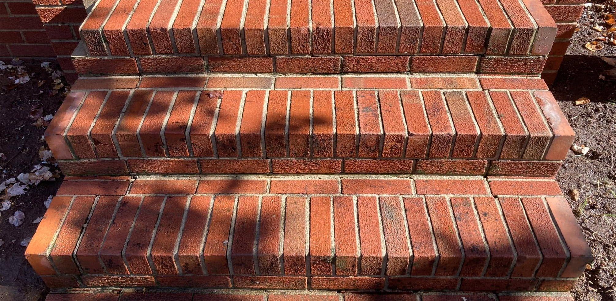 The same brick steps bright red with clean joints after washing