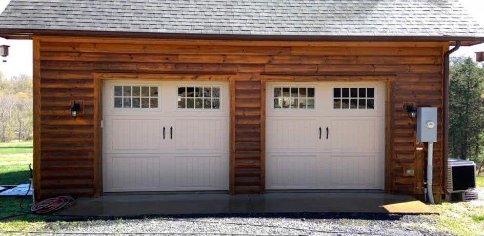 The same log-sided garage with clean, warm-toned logs after washing