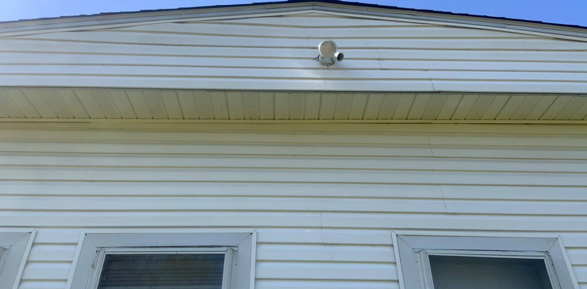 The same soffit and gable clean and white after a soft wash