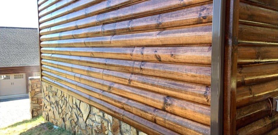 The same log wall showing clean wood grain after washing