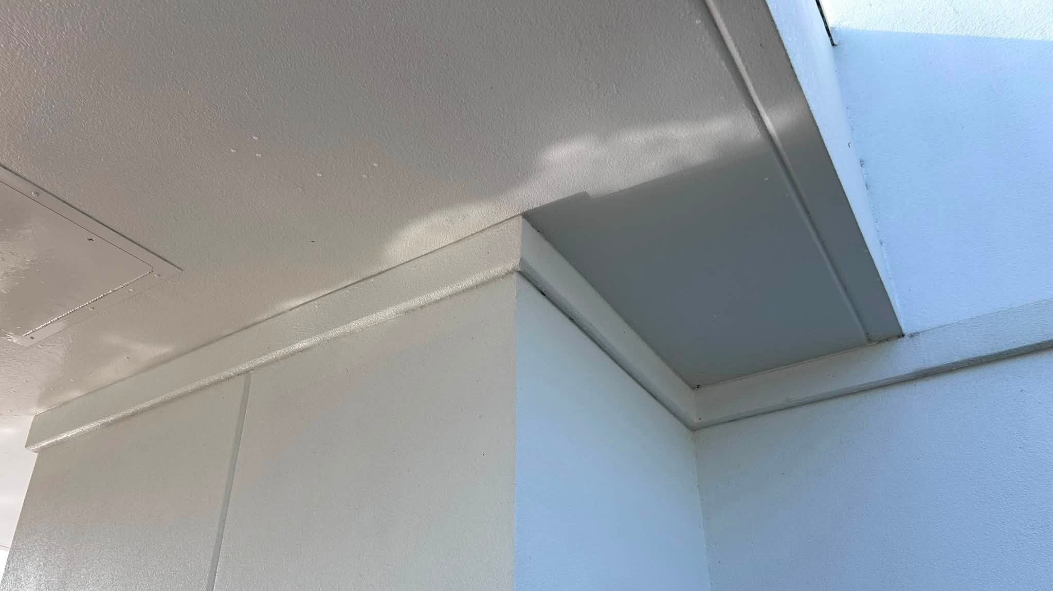 Clean white stucco corner and soffit on a commercial building after washing