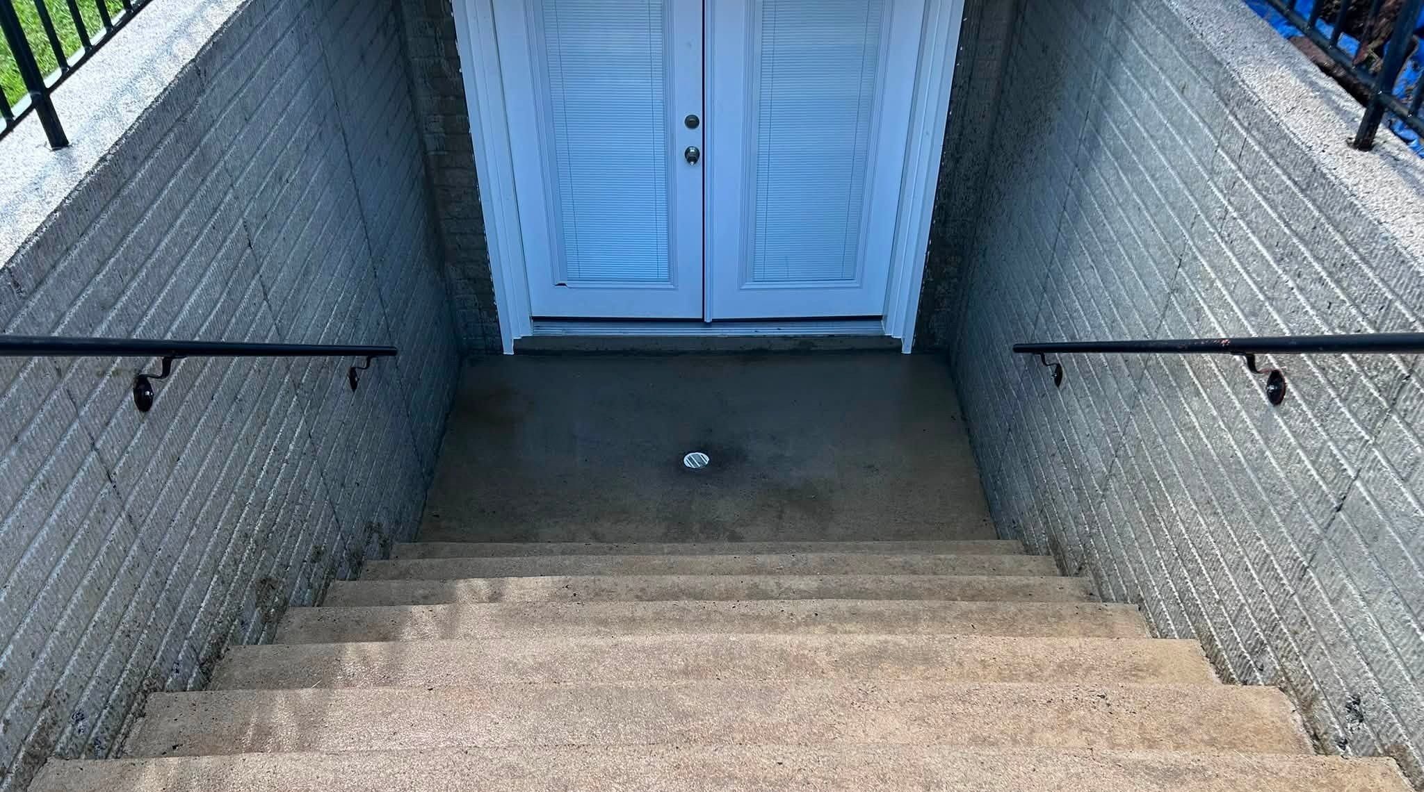 The same basement stairwell steps and landing after washing, still wet
