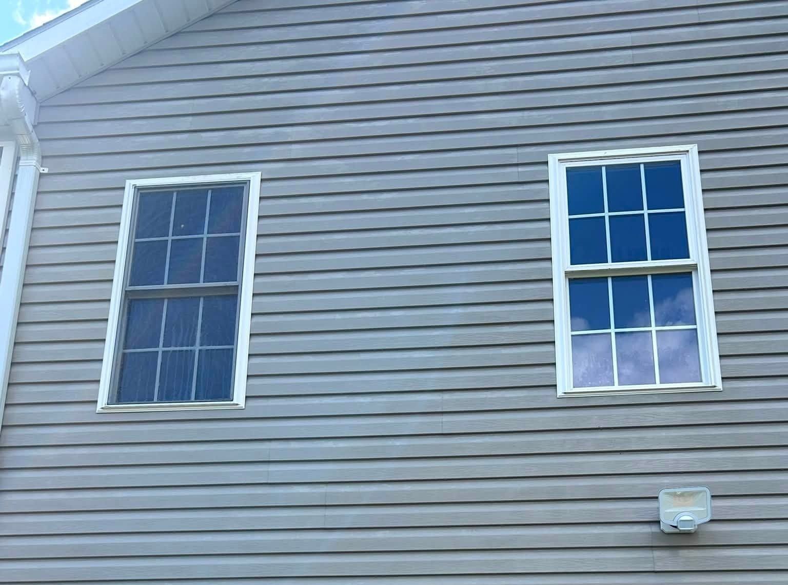 The same siding and windows after a soft wash, mildew streaks gone