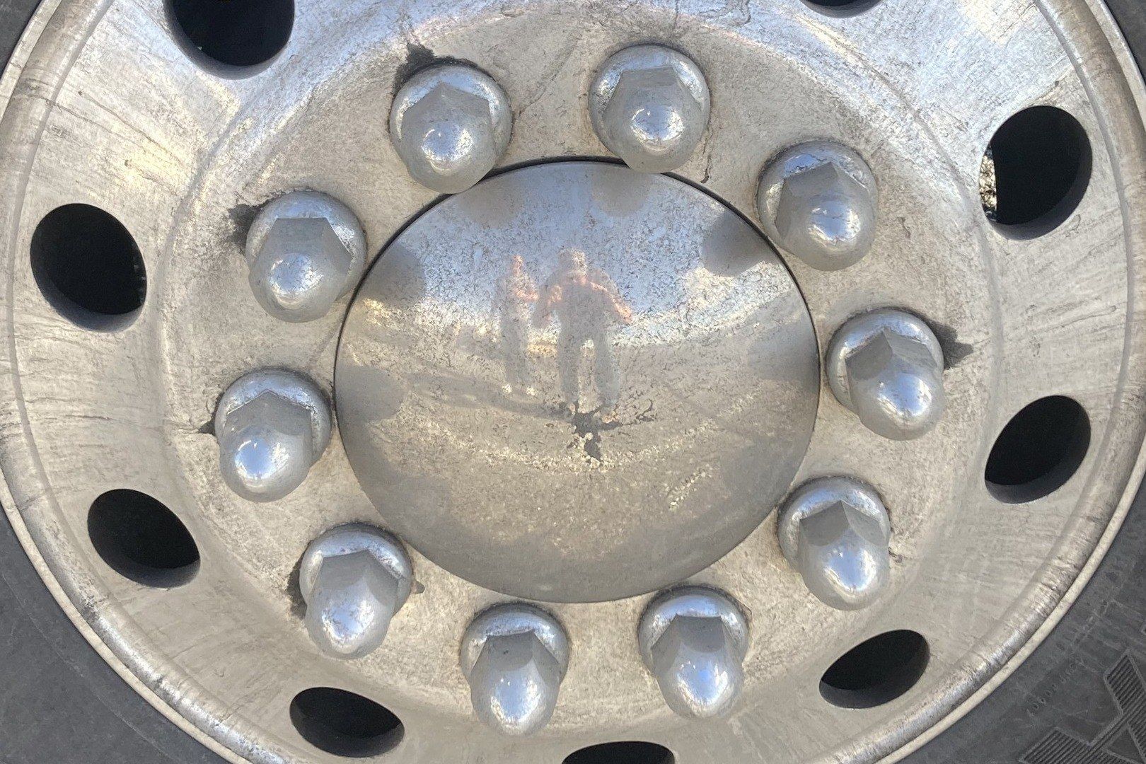 Aluminum truck wheel with lug nut covers before fleet washing
