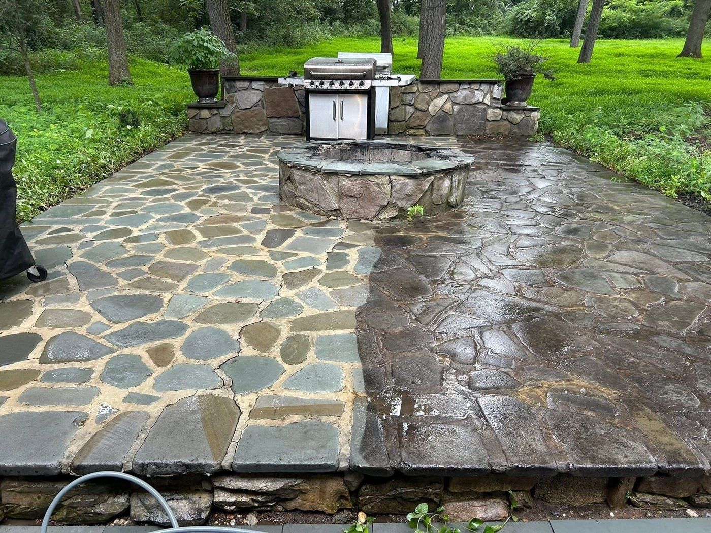 Flagstone patio with a stone fire pit, the left half washed to blue-gray stone and the right half still dark