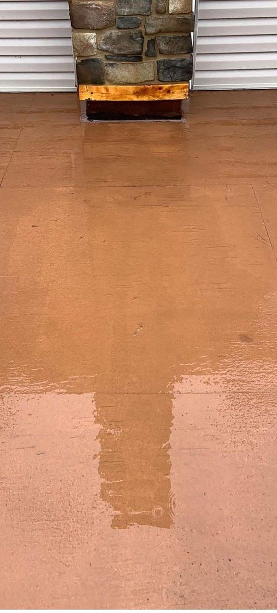 The same floor after rust stain removal, still wet from washing