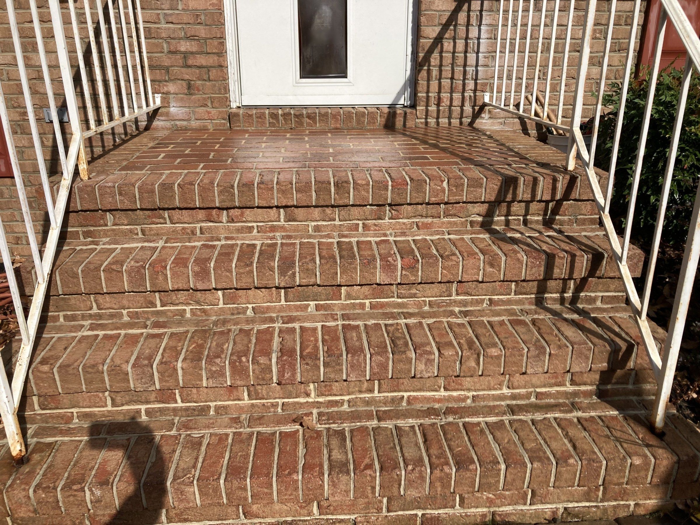 The same brick front steps clean and even-toned after washing